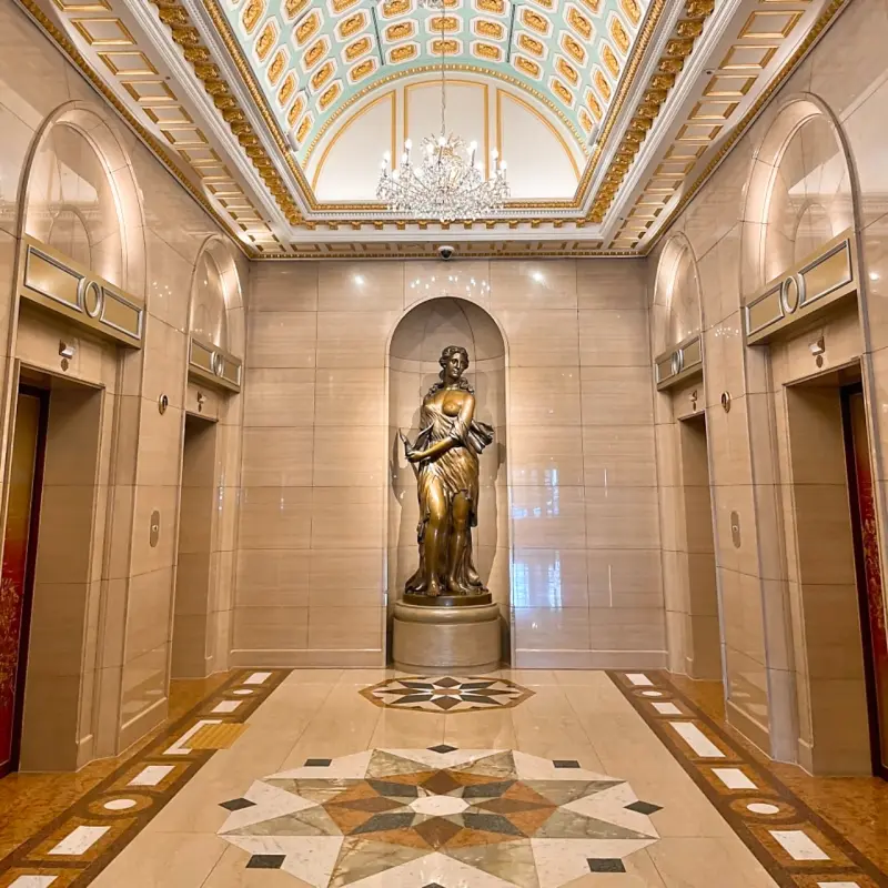 Luxury hallway with chandelier and golden statue