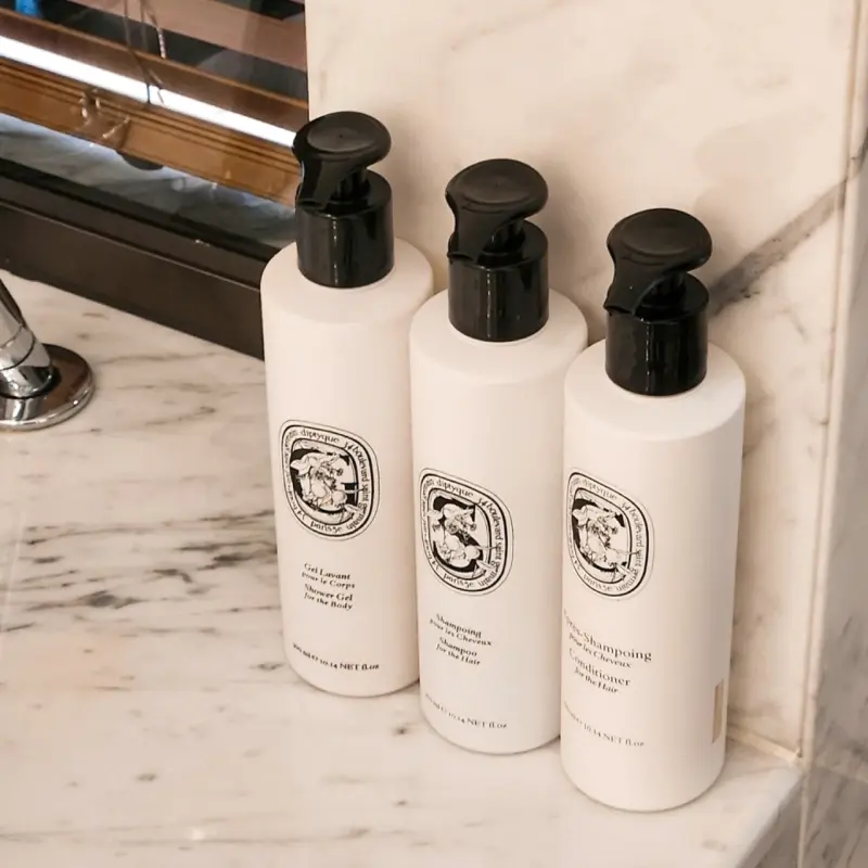Diptyque bath amenities in marble bathroom