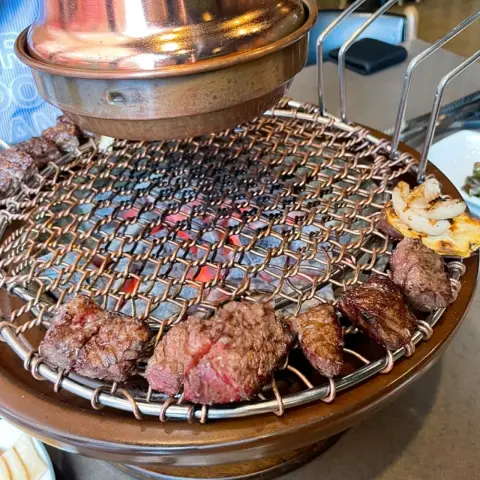 Meat grilled over charcoal at Maple Tree House Itaewon’s copper grill
