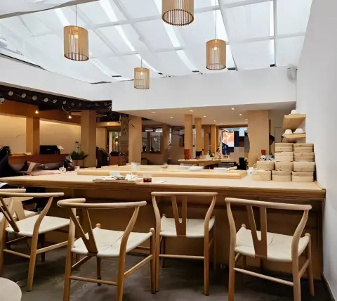 Hanok-inspired café interior with bamboo lighting and bar seats