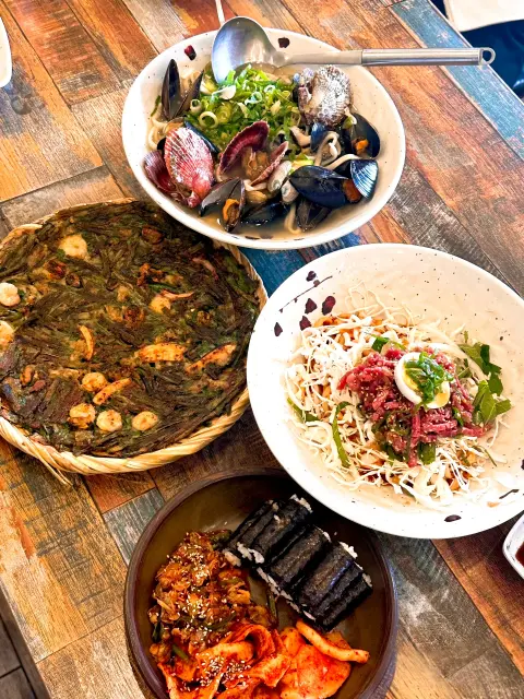 Top dishes from Nasari Sigdang laid out on a rustic table