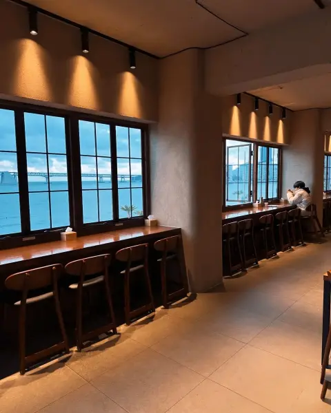 Evening view seating at Nasari Sigdang with Gwangalli Bridge in the distance
