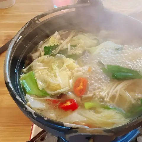 Hot pot bubbling with vegetables and broth at Oncheonjip