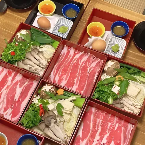 Oncheonjip full table setup with meat boxes, eggs, and condiments