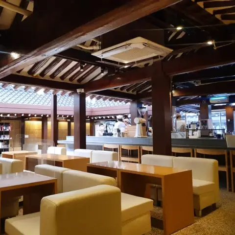 Cafe onhwa ikseon main hall with exposed roof beams and central bar