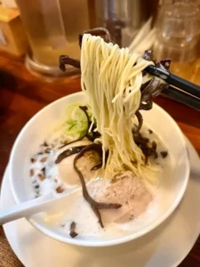 Oreno Ramen Insa creamy chicken ramen noodles lifted with chopsticks