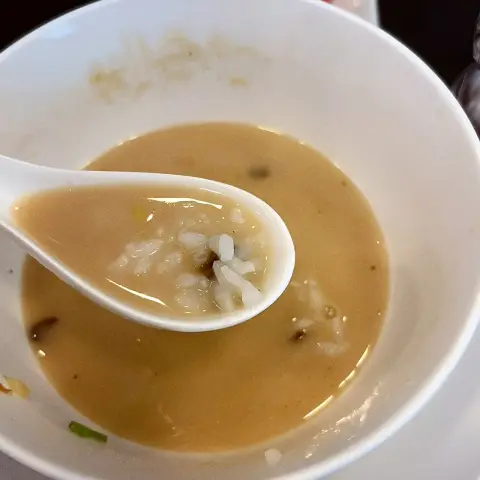 Rice mixed into creamy chicken ramen broth at Oreno Ramen Insa