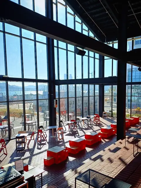 Second-floor panoramic view of harbor through industrial glass windows
