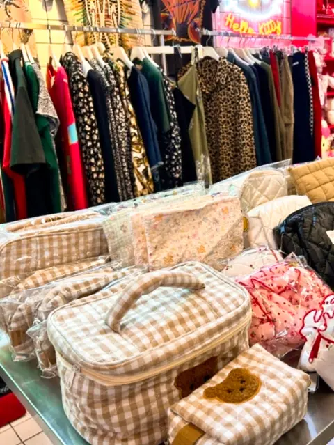 Trendy fashion and pouch display with gingham and floral patterns