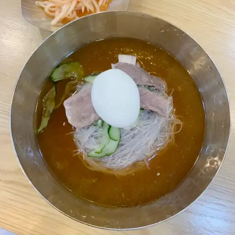 Gangnam Myeonok Insadong mul-naengmyeon topped with beef and boiled egg