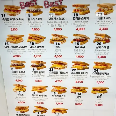 Wall menu showing popular toast items with prices in Korean at the Myeongdong branch