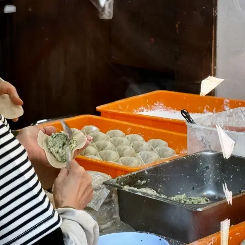 Gaeseong Mandu Koong handmade dumplings being prepared fresh in the kitchen