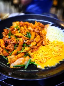 Cheese fondue sizzling with Shin Mi Kyung Hongdae Dakgalbi on a hot plate