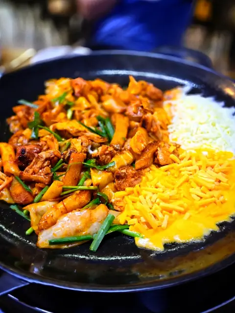 Cheese fondue sizzling with Shin Mi Kyung Hongdae Dakgalbi on a hot plate