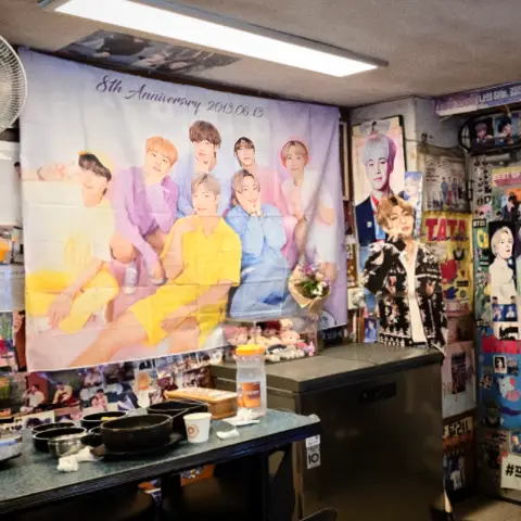 Yoojung Sikdang dining area decorated with BTS banners and posters