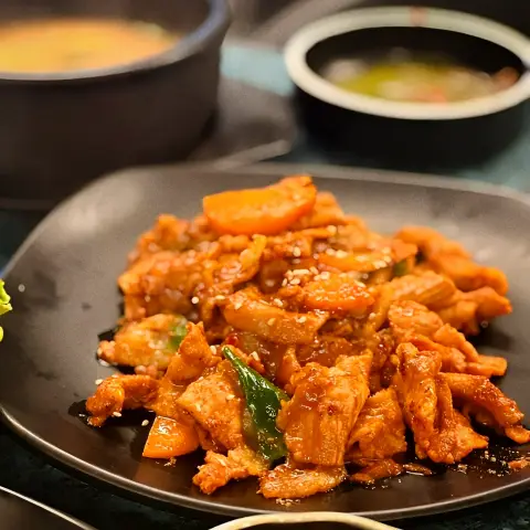 Black pork jeyuk bokkeum served hot at Yoojung Sikdang