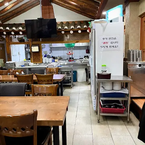 Kitchen area and self-service banchan station at Jaedong Sundubu.