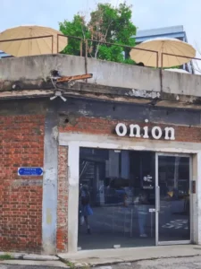 Cafe Onion Seongsu exterior with red brick facade and rooftop parasols in Seongsu-dong